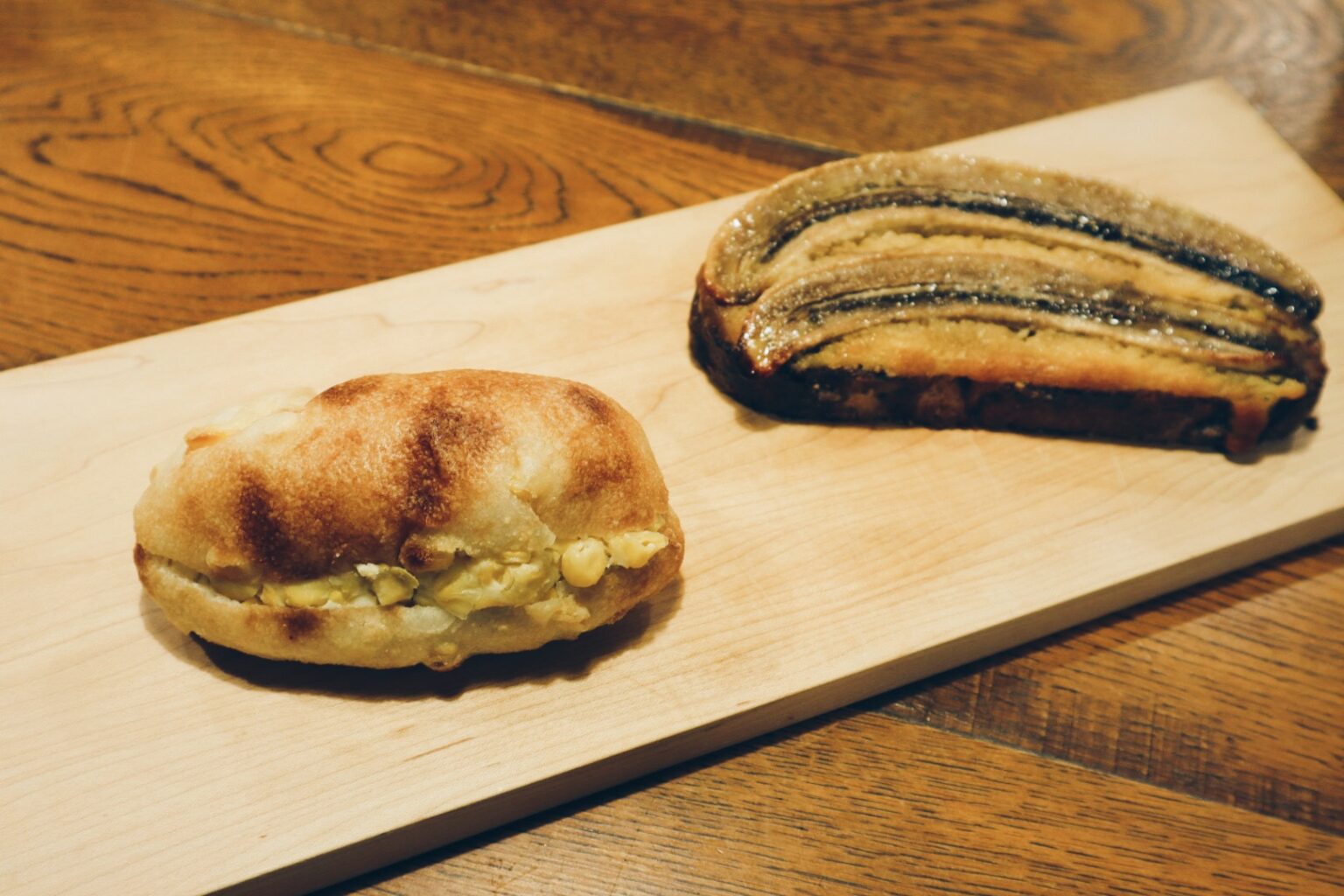 （左から）「塩バターコーンパン」「バナナとピーカンナッツのタルティーヌ」。（撮影：花井悠希）