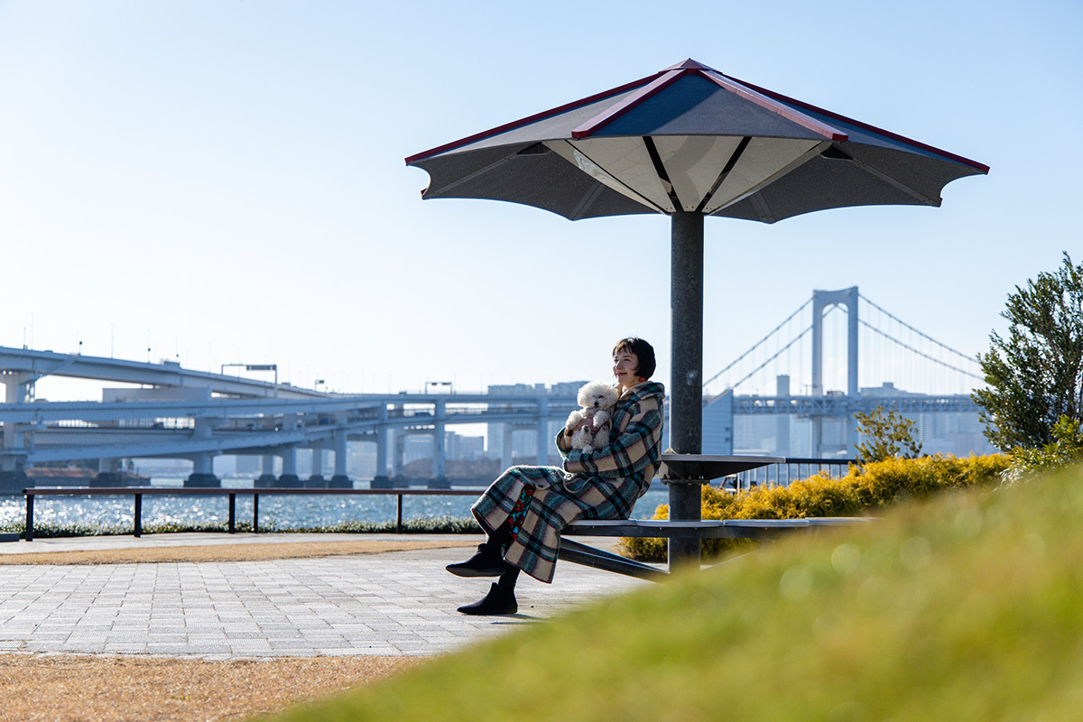 豊洲ぐるり公園で犬と散歩させる女性